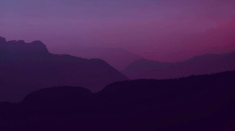 A Purple Sky With Mountains Wallpaper