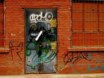 Graffiti Door In Brick Wall