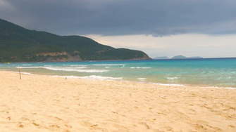 Beautiful Of Sandy Beach And Waving Blue Sea Water With