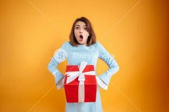Amazed Shocked Young Woman With Opened Mouth Holding Present Box