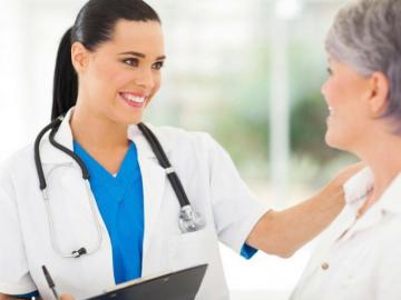Female Doctor Smiling With Patient Off The Cusp