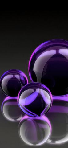 Three Black And Purple Balloons Of Different Sizes