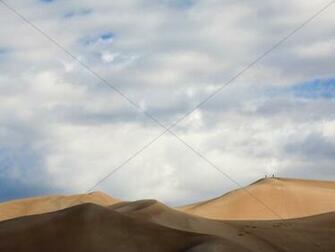 Desert Dunes With Cloudy Sky