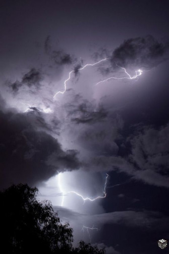 Lightning Strikes Through Dark Clouds Wallpaper