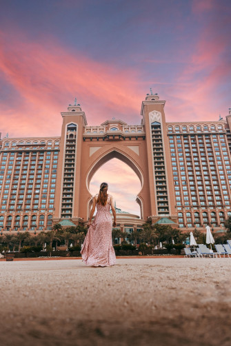 A Person In Dress Standing Front Of Large Building With