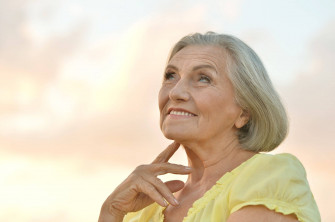Mature Woman Enjoying A Conversation Over The Phone Wallpaper