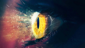 Intense Gaze Through Shattered Glass Wallpaper