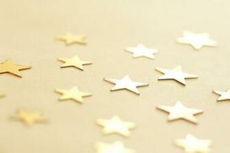Gold Stars Scattered On Neutral Background