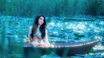 Girl With Flowers Sitting In The Boat Wallpaper