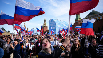 Putin Uses Public Holiday To Laud Patriotic Feelings As Support