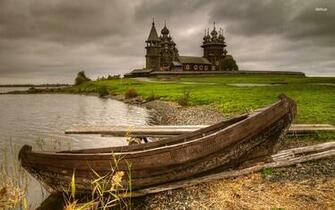 Old Boat On Rocky Shore By Thewooden Church World