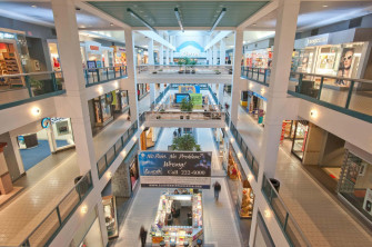 Enjoy The Vibrant Atmosphere Of Modern Shopping Mall Wallpaper