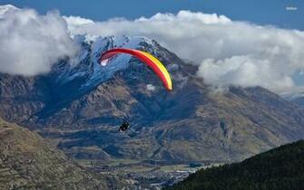Man Paragliding In The Mountains Wallpaper Sport
