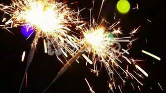 Burning Sparklers On The Background Of Christmas Illuminations