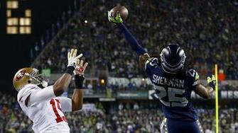 Cornerback Richard Sherman Of The Seattle Seahawks Tips Ball