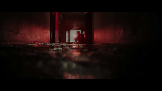 Eerie Hallway Figure Wallpaper