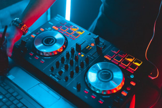 Black Dj Controller Turned On In Dim Light Room Photo