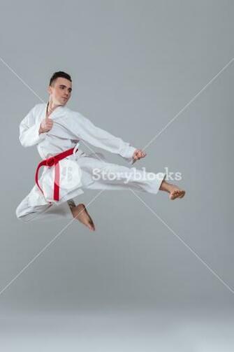 Photo Of Sportsman In Kimono Practice Karate While Jumping