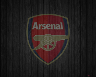 Logo Of Arsenal Football Club Designed On A Black Wooden