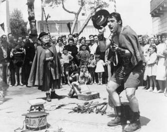 Grayscale Photo Of Clown Man Surrounded By Crowd La Strada