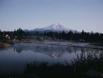 A Lumber Mill With Mount Shasta In The Background