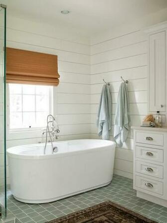 Serene Bathroom With Shiplap Paneled Walls Framing Sunny Window