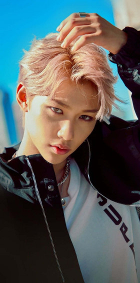 A Man With Pink Hair Posing His Head Down Wallpaper