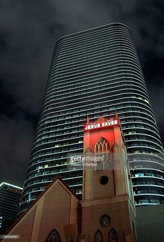 Small Church With Red Neon Jesus Saves Sign Shining At Night