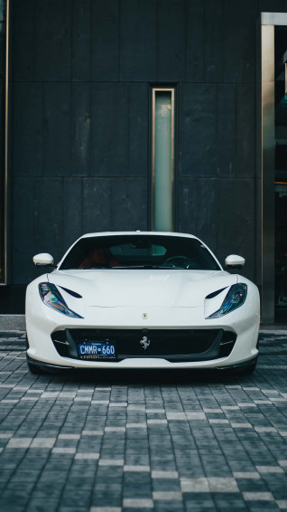 Driving Luxury In Style With A White Ferrari iPhone Wallpaper