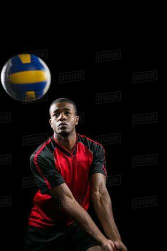 Sportsman Playing A Volleyball On Black Background Stock Photo