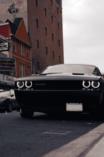 Black Bmw Car Parked Beside Brown Building During Daytime Photo