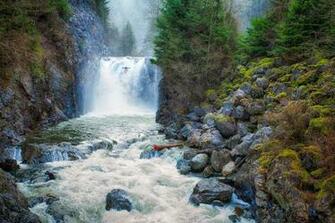Kayaker Waterfall On Beach Wallpaper