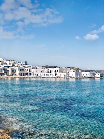 White Concrete Building Beside Body Of Water During Daytime Photo