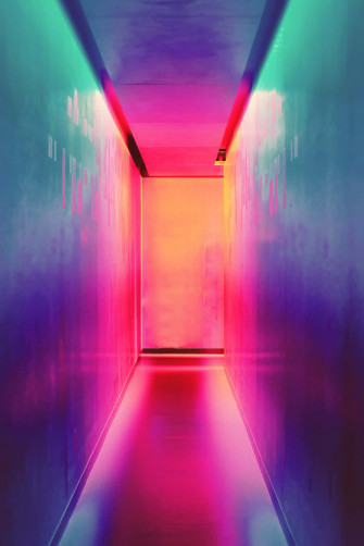 A Neon Lit Hallway With Blue Wall Wallpaper