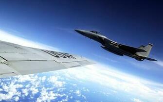 Eagle Flies Alongside A Kc Stratotanker