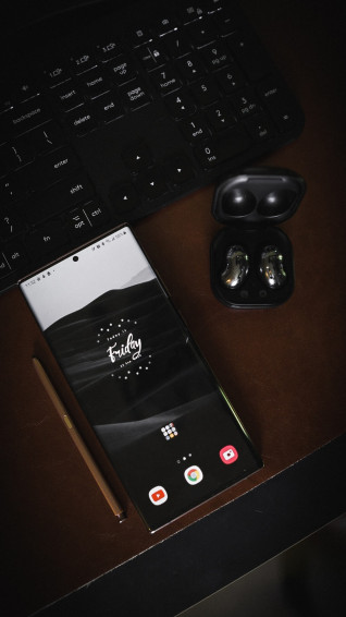 Black Lg Android Smartphone On White Paper Photo Grey Image