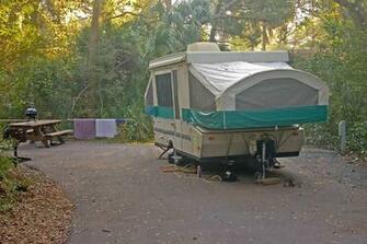 Of A Pop Up Tent Trailer With Picnic Table In The Background
