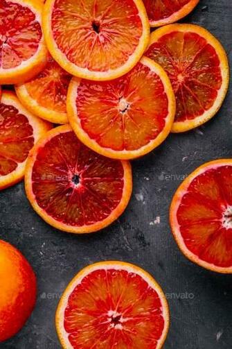 Sliced Ripe Juicy Sicilian Blood Oranges On Dark Background Stock