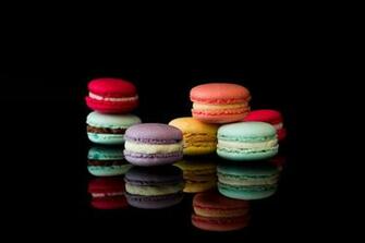 Yummy Macarons On Black Glossy Background Isolated Stock