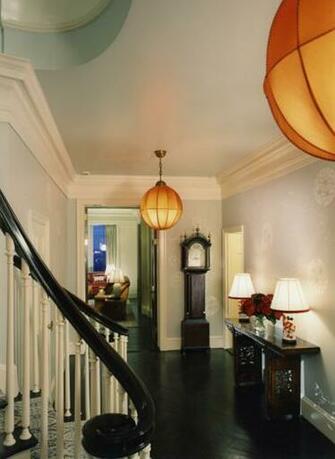 Herringbone Wood Floored Entryway And Stairs With Circular Pendant