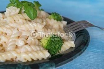 Pasta On Plate Blue Wooden Background Stock Photo Thinkstock