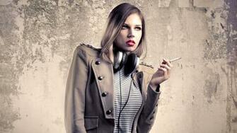 Girl Smoking Next To A Concrete Wall Wallpaper