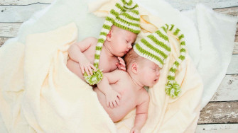 Adorable Twin Babies Smiling And Laughing Together Wallpaper