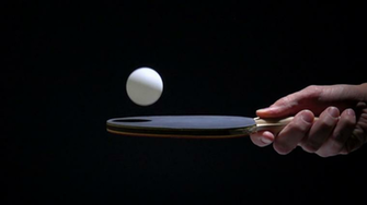 Hand Holding Table Tennis Racket And Bouncing Ping Darkness