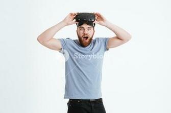 Photo Of Young Shocked Bearded Man Wearing Virtual Reality Device