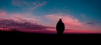 Photo Silhouette Of Human With Sunset Background Backlit