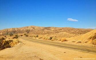 Riding Through The Oranges And Tans Of Desolate California Desert