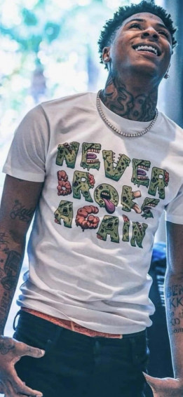 A Man With Tattoos And T Shirt That Says Never Broke