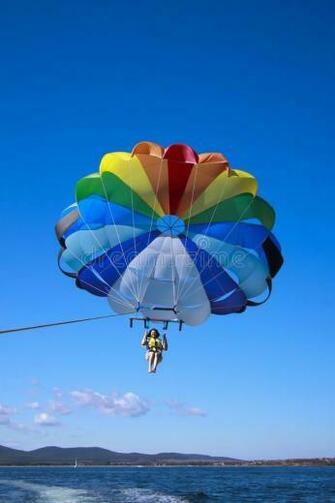 Parasailing Woman Is On Blue Sky Background Aff
