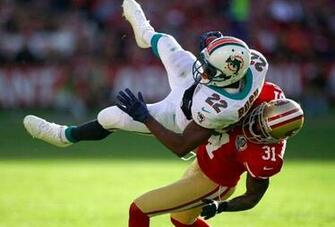 Reggie Bush Left Is Stopped With The Ball By San Francisco 49ers